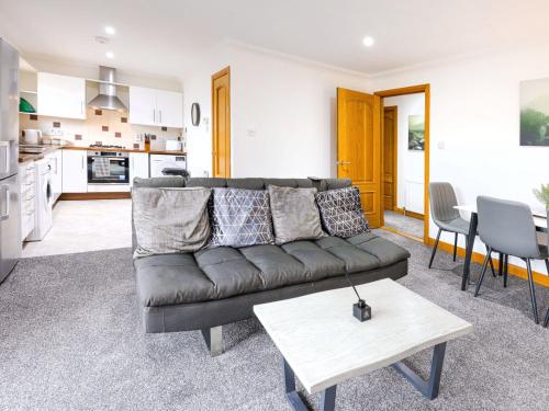 a living room with a couch and a table at Apartment Forres View by Interhome in Forres