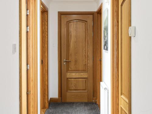 a hallway with a wooden door in a room at Apartment Forres View by Interhome in Forres
