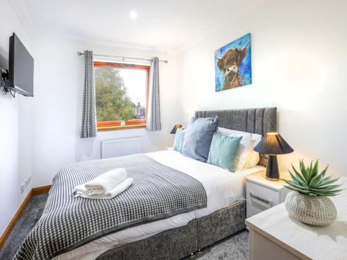 a bedroom with a bed and a window at Apartment Forres View by Interhome in Forres