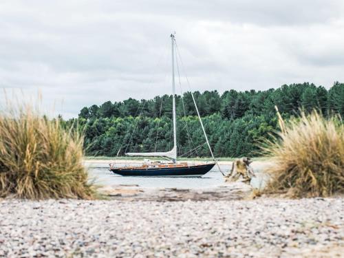 a boat sitting in the water on a beach at Apartment Forres View by Interhome in Forres