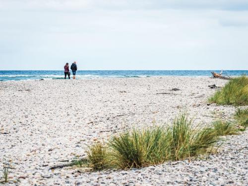 two people standing on a beach near the ocean at Apartment Forres View by Interhome in Forres