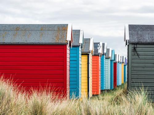 a row of colorful beach huts on the beach at Apartment Forres View by Interhome in Forres