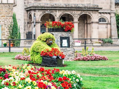 a flower garden in front of a building with flowers at Apartment Forres View by Interhome in Forres