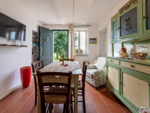 a kitchen and dining room with a table and chairs at Holiday Home Casetta di Agnese by Interhome in San Damiano dʼAsti