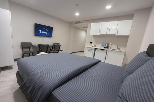 イスタンブールにあるDolapdere Luxury Suites Hotelのベッドルーム1室(ベッド1台付)、キッチン(椅子付)
