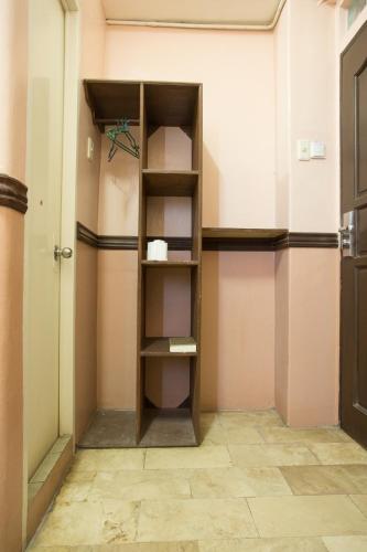 a book shelf in a room with a door at GV Hotel - Masbate in Masbate