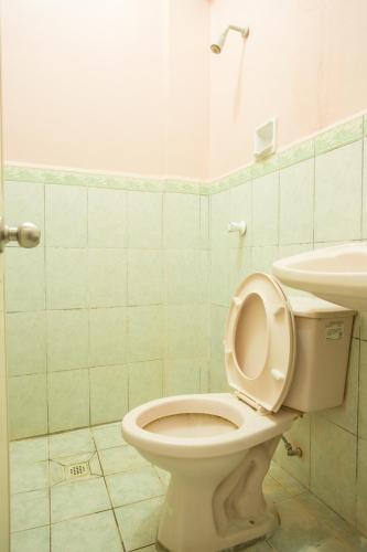 a bathroom with a toilet and a sink at GV Hotel - Masbate in Masbate