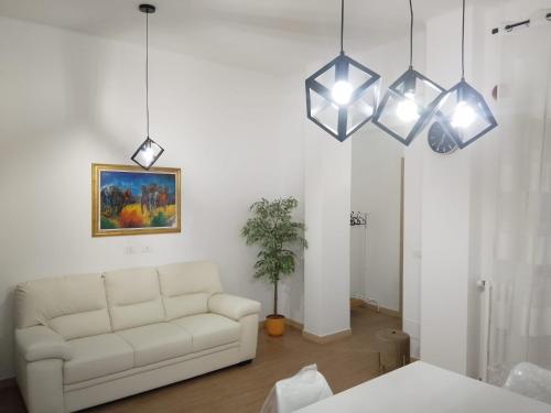 a living room with a white couch and three lights at Dimora MiRà in Adelfia