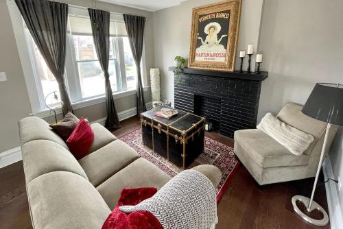 a living room with a couch and a fireplace at The Chocolate Suite - Walkable and Peaceful home in Tower Grove