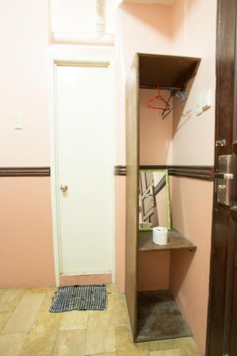 a kitchen with a door open to a refrigerator at GV Hotel - Masbate in Masbate