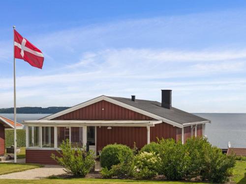 a house with a canadian flag in front of it at Holiday Home Fani - 150m from the sea by Interhome in Børkop
