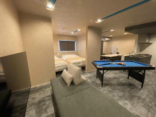 a room with a ping pong table and a bed at HIRARI Mizubenomori - Vacation STAY 08869v in Chikugo