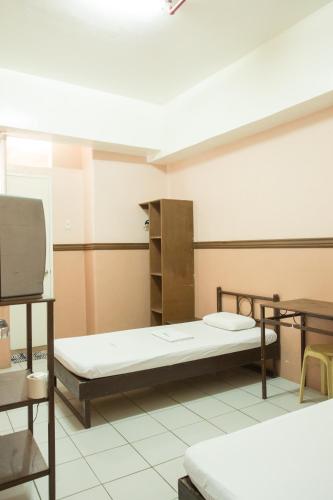 a hospital room with two beds and a tv at GV Hotel - Masbate in Masbate