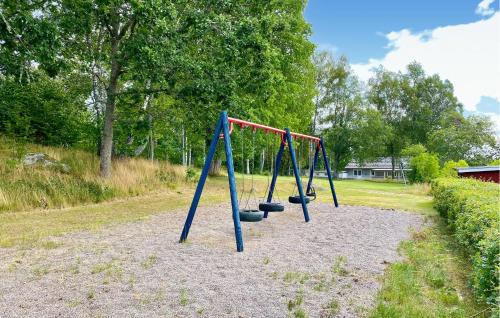 a row of swings in a park at Beautiful Apartment In Pauliström in Pauliström