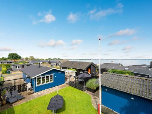 an aerial view of a blue house with a yard at Holiday Home Urda - 50m from the sea by Interhome in Binderup Strand