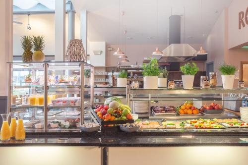 a buffet line with many different types of food at Garner Hotel Elmshorn by IHG in Elmshorn