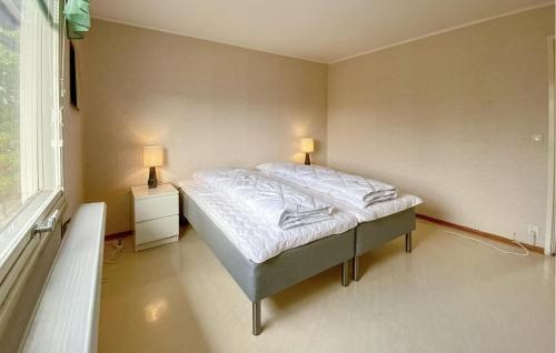 a bedroom with a bed with two lamps on it at Beautiful Apartment In Pauliström in Pauliström