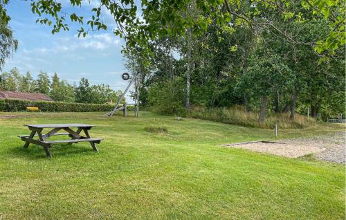 a picnic table sitting in the grass in a park at Beautiful Apartment In Pauliström in Pauliström