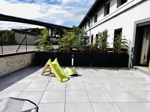 two yellow objects are sitting on a patio at Le Terracotta cocon moderne à 2 pas de la Gare ligne directe GENÈVE-LYON-PARIS in Bellegarde-sur-Valserine