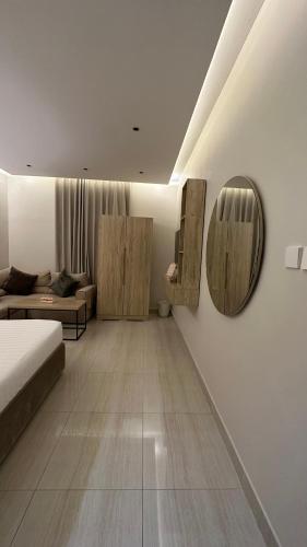 a bedroom with a bed and a mirror on the wall at AN Studios in Al Khobar