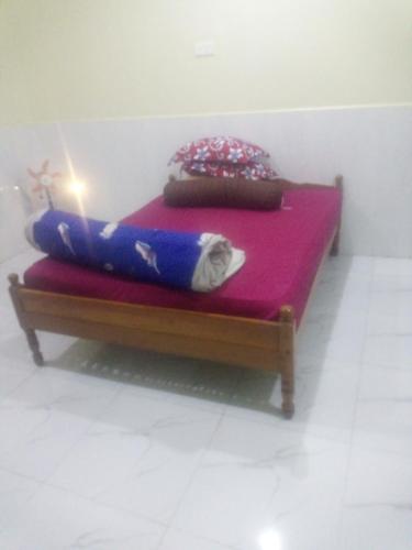 a small bed with a candle on top of it at Homestay Srey Mom in Kampot