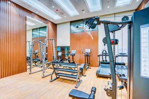a gym with several tread machines in a room at Sunday Hotel & Residences Gurugram in Gurgaon