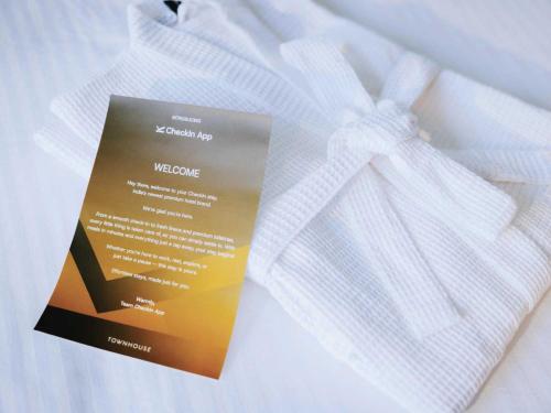 a white shirt with a welcome sign on it at Sunday Hotel & Residences Gurugram in Gurgaon