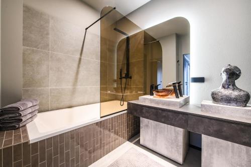 a bathroom with a shower and a sink at Jacuzzi Cinema Shibui 5 in Kaunas