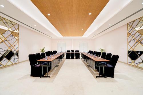 a large conference room with a long table and chairs at Sunday Resort & Spa Manesar Gurugram in Gurgaon