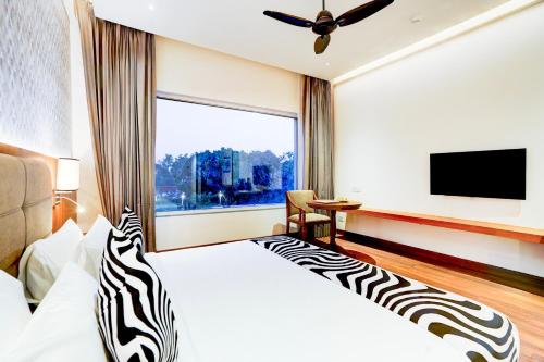 a zebra themed bedroom with a large window at Sunday Resort & Spa Manesar Gurugram in Gurgaon