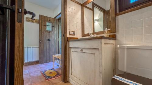 a bathroom with a sink and a mirror at Guils Cal Peiró in Guils de Cerdaña