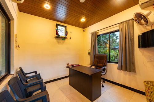 Una televisión o centro de entretenimiento en Dandeli Cottages - Resort