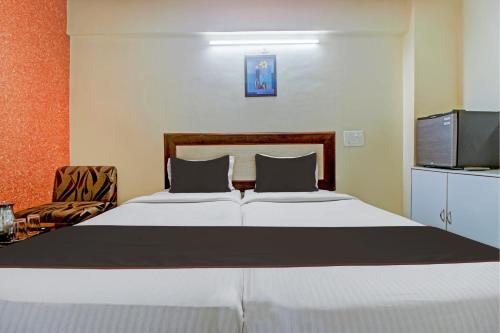 a bedroom with a large white bed and a television at Palette Hotel Pune, MIDC Chinchwad in Chinchiwad