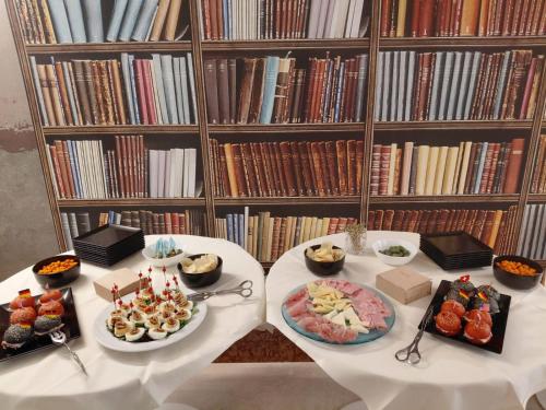 a table with two plates of food in a library at Hotel Giada Viale del Sole in Vicenza