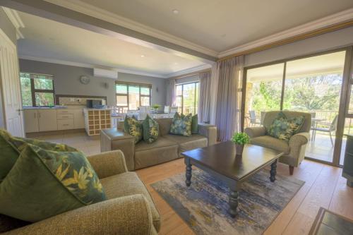 a living room with couches and a coffee table at 156 on Clarens in Clarens
