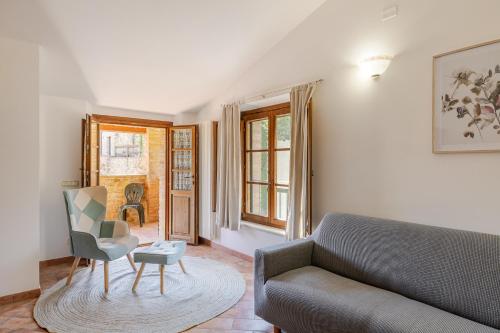 a living room with a couch and a chair at Casa Baiocco in Città della Pieve