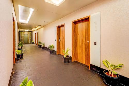 an office corridor with potted plants in a row at HOTEL THE SLATE Near APOLLO HOSPITAL & US EMBASSY in Chennai