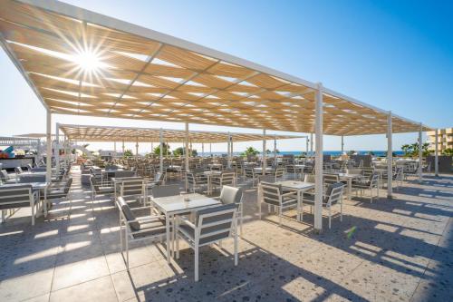 a group of tables and chairs under a pavilion at Seven Seas Jolie Bay - Ultra All Inclusive in Hurghada