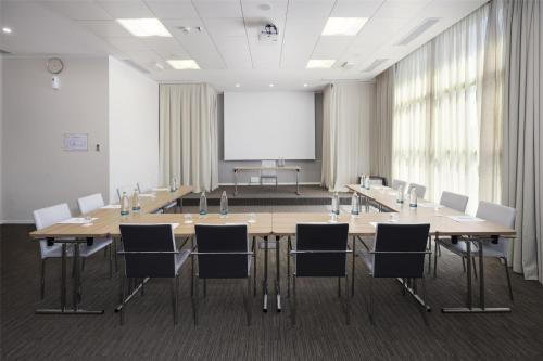 a conference room with a large table and chairs at Best Western Premier CHC Airport in Genova