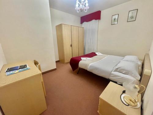 a hospital room with a bed and a cabinet at Albergo Casa Sperti in Spert