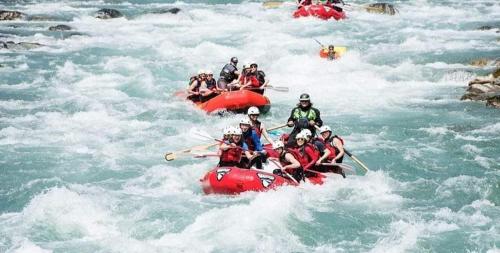 a group of people in red rafts in the water at Kelani Riverside Retreat in Kitulgala