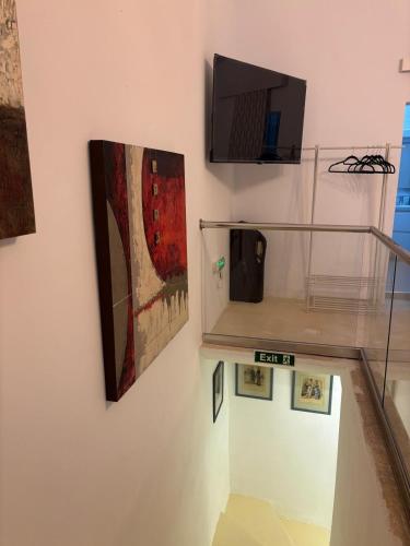 a museum exhibit with paintings on a wall at Vincenti's Rest in Birgu - a traditional old house in Birgu