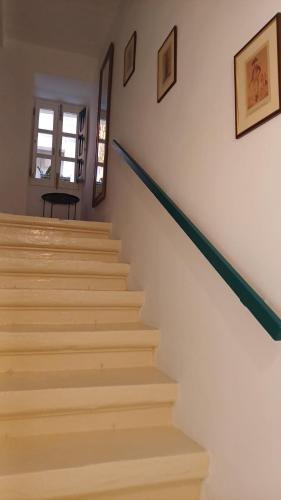 a staircase in a home with white walls at Vincenti's Rest in Birgu - a traditional old house in Birgu