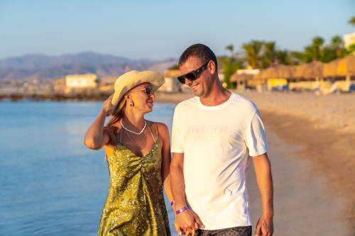 a man and a woman standing on the beach at Seven Seas Jolie Bay - Ultra All Inclusive in Hurghada