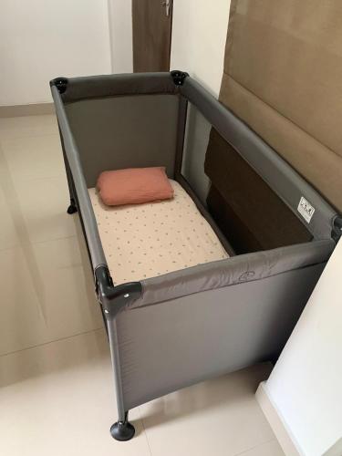 a small bed in a room with avertisementatronatronatronstrationstrationstrationstration at The Chocolate Factory House, Kandy- exclusive private apartment in Kandy