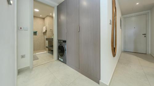 a laundry room with a washer and dryer in a house at Breathtaking Sea View Retreat by Hala Homes in Ras al Khaimah