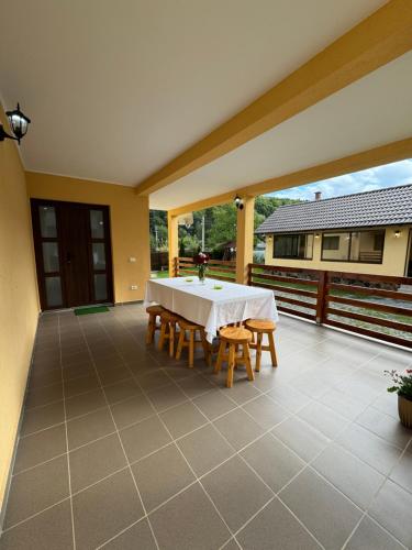a large patio with a white table and chairs at Casa Abrudan in Scrind-Frăsinet