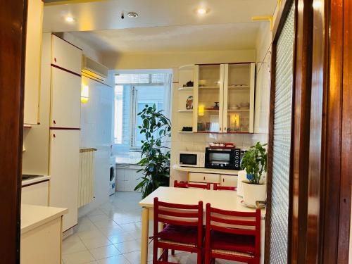 a kitchen with two chairs and a table in a kitchen at Luxury Relax Apartment near Venice Station in Venice