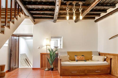 a living room with a couch and a staircase at Staymoz in Estremoz