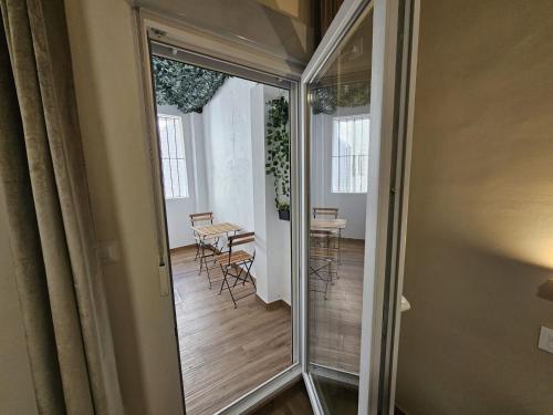 a glass door leading into a room with a table and chairs at Zaida Boutique Hotel in Seville